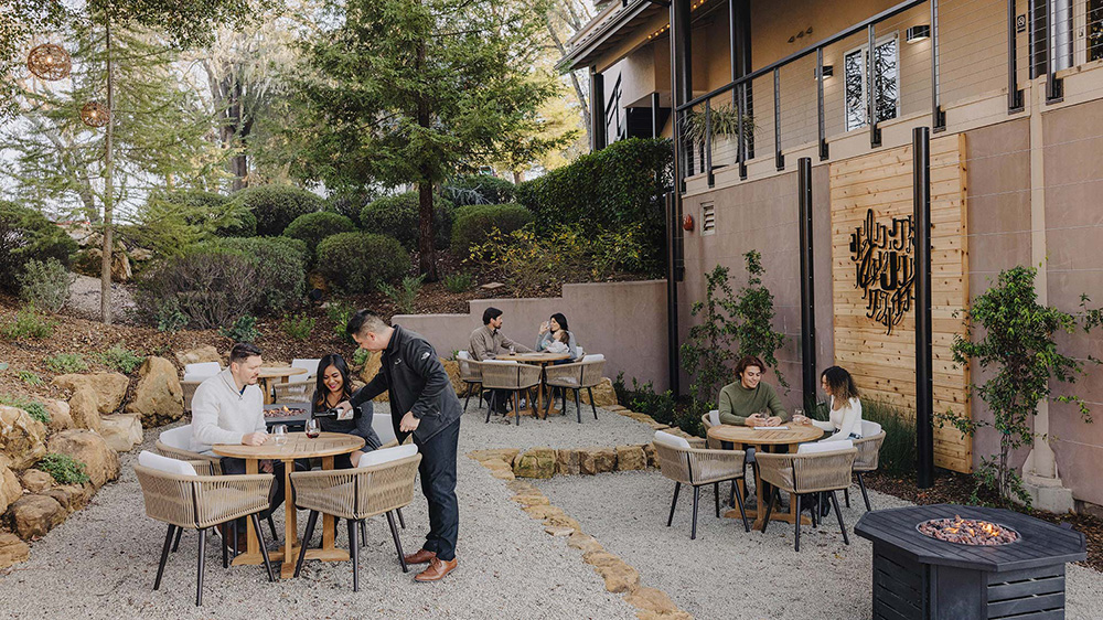 People enjoying outdoor tasting area at Jada Vineyard