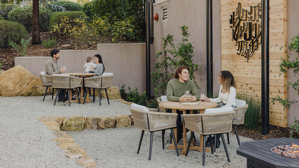 People sitting at outdoor tasting area at Jada Vineyard