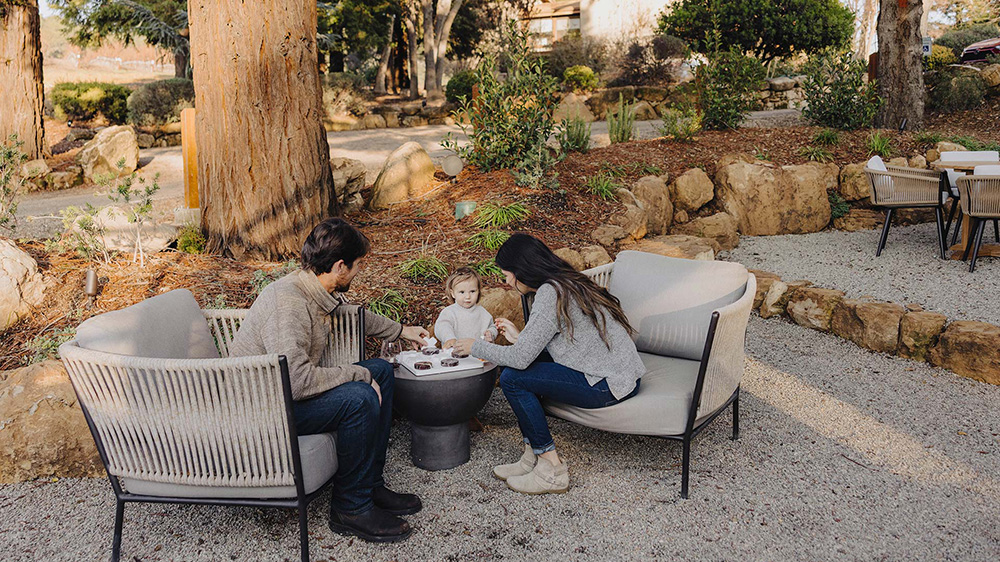 Young family sitting outside at Jada Vineyard