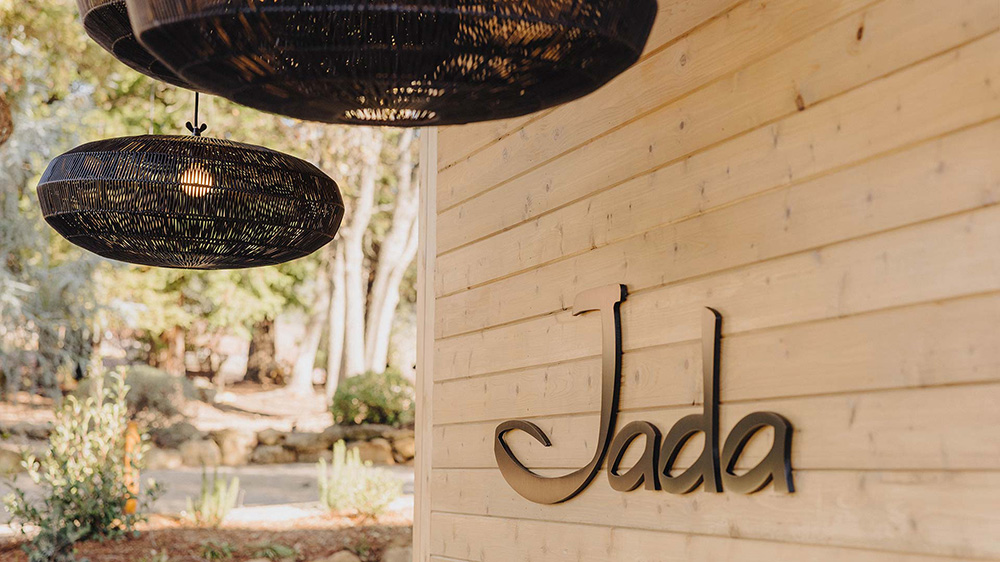 Jada logo on wood panel wall
